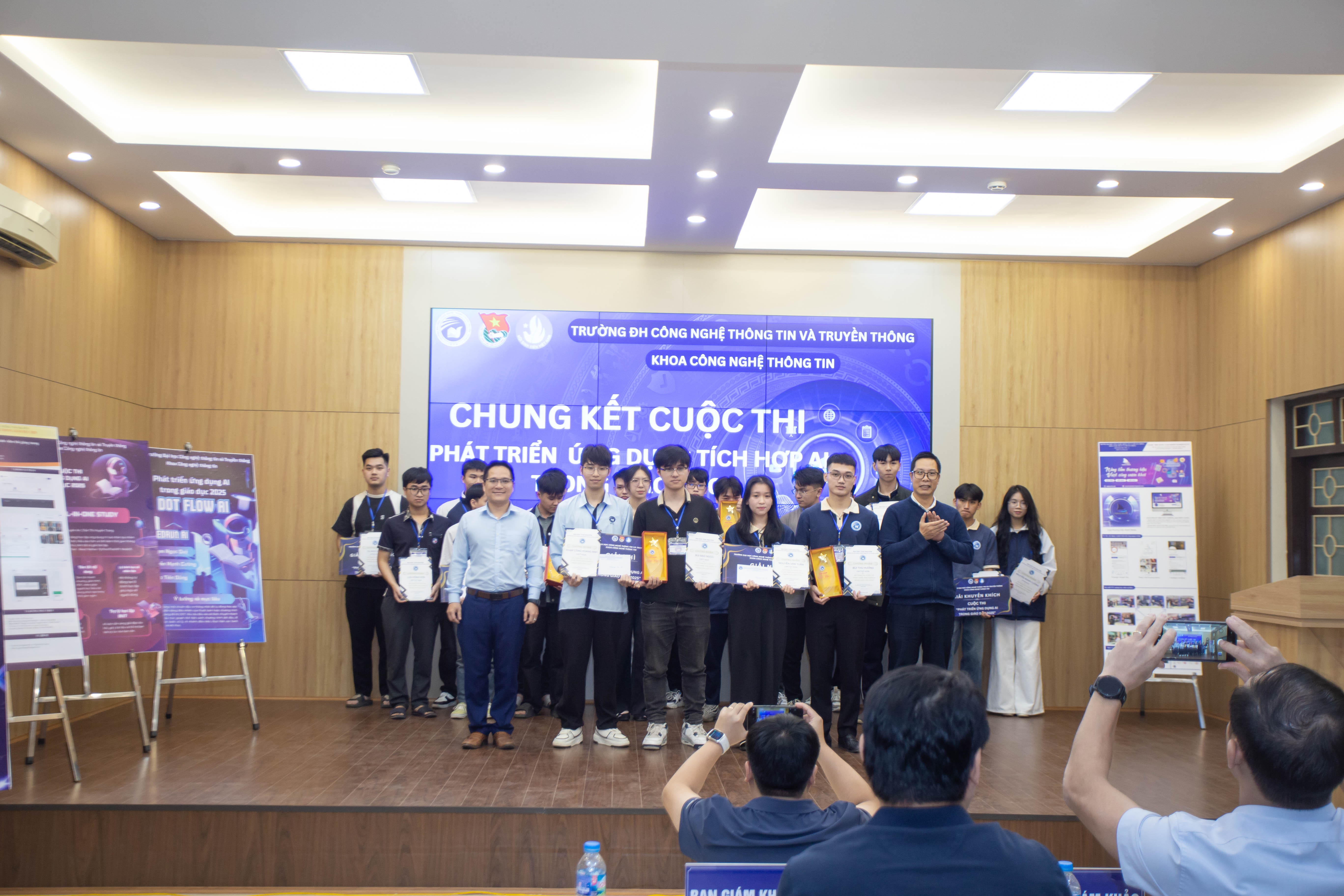 Team photo holding certificate on stage